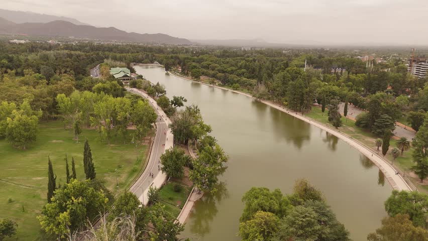 4K 60fps aerial footage over the lake in Parque General San Martin, Mendoza, Argentina. Features the Andes mountains in the background