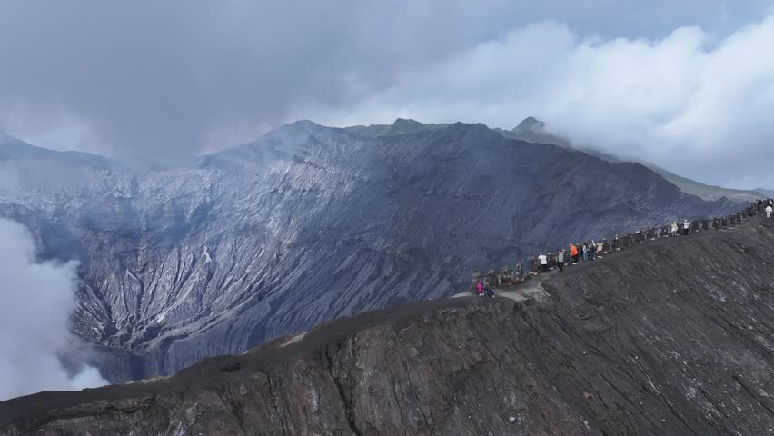 aerial view flying to mount Bromo active volcano above sea of clouds, Java, Indonesia