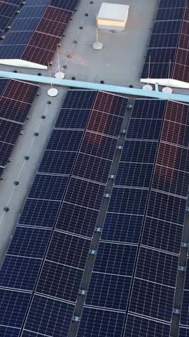 Solar panels on top of commercial building, aerial vertical view