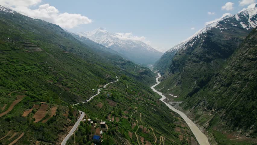 4K Aerial view of Chandra river flowing through Himalaya mountains in Lahaul, Himachal Pradesh, India. Summer travel concept. Mountain landscape, nature background.