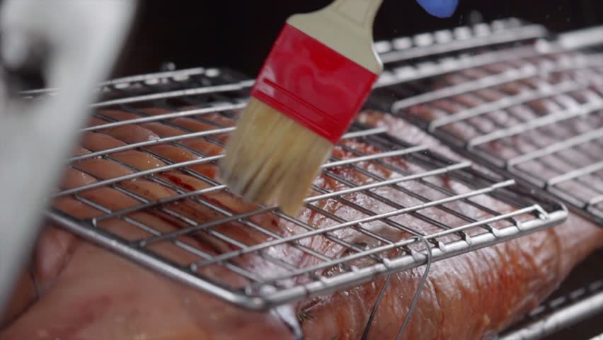 Prepare the pork before grilling by brushing with spices with a brush