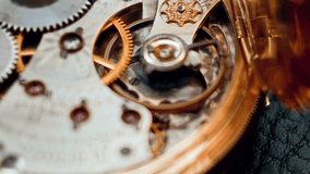 Selective camera focus highlights the intricate golden gears and details of a vintage pocket watch. The cinematic macro video captures sharp textures, polished mechanics, and ornate craftsmanship. - Powered by Shutterstock - Get 15% off with code: PIKWIZARD15