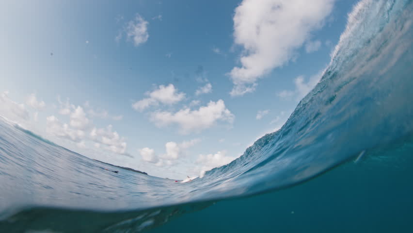 Split view of powerful ocean wave. Wave forms a tube and breaks. Maldives