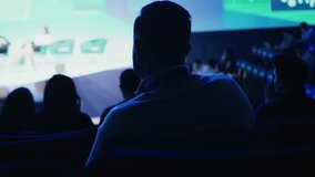 Attendee watching presentation on stage at conference - Powered by Shutterstock - Get 15% off with code: PIKWIZARD15