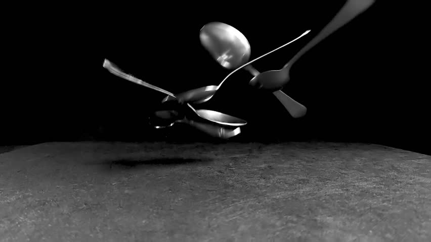 Metal spoons - cutlery. Steel spoons on black background. Slow motion