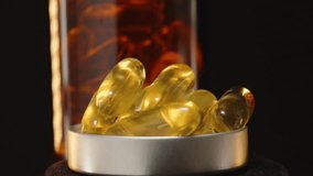 Looping 360-Degree Rotation of a Bottle Cap Filled with Omega 3 Capsules in Front of a Brown Glass Bottle Against a Dark Background with Warm Light Reflections - Powered by Shutterstock - Get 15% off with code: PIKWIZARD15