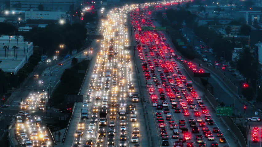 Drone flying over a traffic jam, dark, hazy evening on a American Interstate