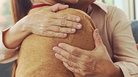Closeup hands of elderly mother and Asian daughter teen sitting and hugging each other gently, comforting and encouraging, showing love and bonding in a warm home. - Powered by Shutterstock - Get 15% off with code: PIKWIZARD15