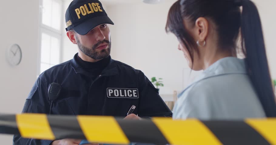 Police officer, member of police force asking woman at crime scene barricade tape, yellow police line, safety warning, police officer, policeman making and processing arrest of young guilty woman