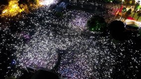 People at the concert - aerial shot taken by drone of thousands of people making lights with their phones at the concert - Powered by Shutterstock - Get 15% off with code: PIKWIZARD15