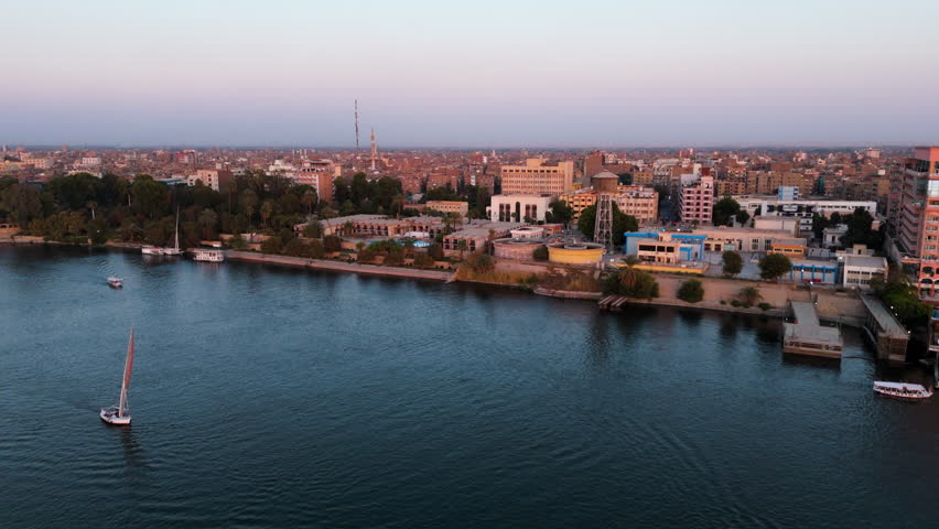 Riverside Cityscape Of Luxor At Sunset On The Banks Of Nile River In Egypt. aerial shot