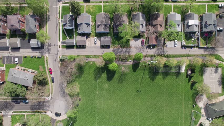 Aerial drone shot and birds eye view of American houses, homes, buildings, businesses, and suburban urban neighborhood of Grandview Heights in Ohio near Columbus, OH city center and downtown town area