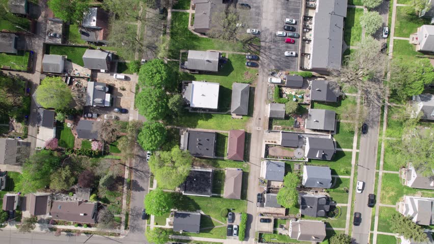 Aerial drone shot and birds eye view of American houses, homes, buildings, businesses, and suburban urban neighborhood of Grandview Heights in Ohio near Columbus, OH city center and downtown town area