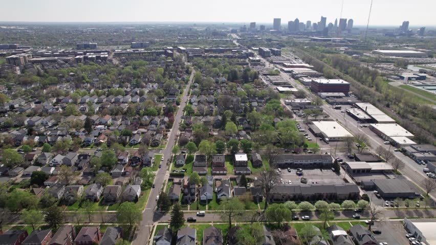 Grandview Heights upper and middle class suburb suburbia neighborhood houses and buildings with Columbus, Ohio city and downtown capital in the background from drone aerial view establishing shot