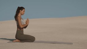 A woman in activewear performs a yoga flow sequence, including child s pose and upward dog, on scenic desert sand dunes under a clear blue sky. Ideal for wellness and mindfulness themes.  - Powered by Shutterstock - Get 15% off with code: PIKWIZARD15