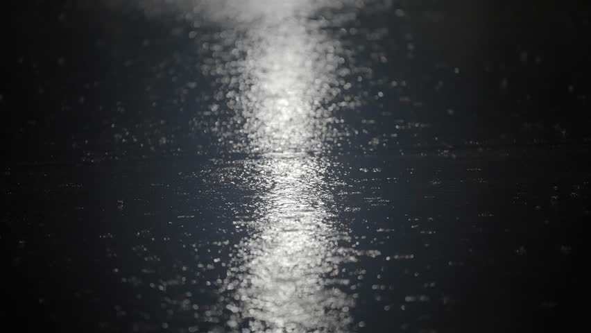 Night Rain Falling on Urban Street with Reflections