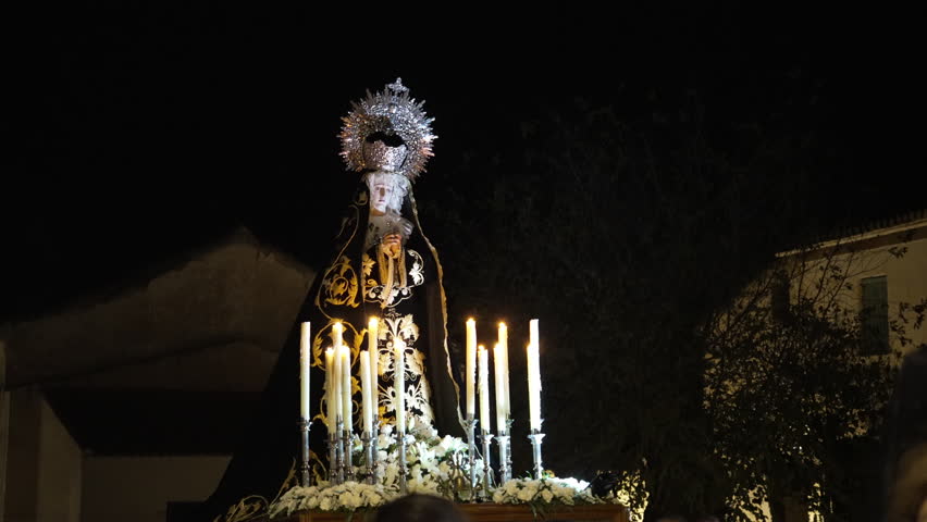 Cinematic 4K close-up of Virgin Mary in the candlelit “Procession of Silence” during Holy Week in Pedro Martínez, Spain. Solemn, spiritual, perfect for cultural or religious content.