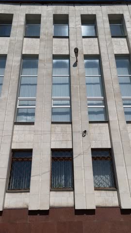 A tall building with many windows on the side of it.
