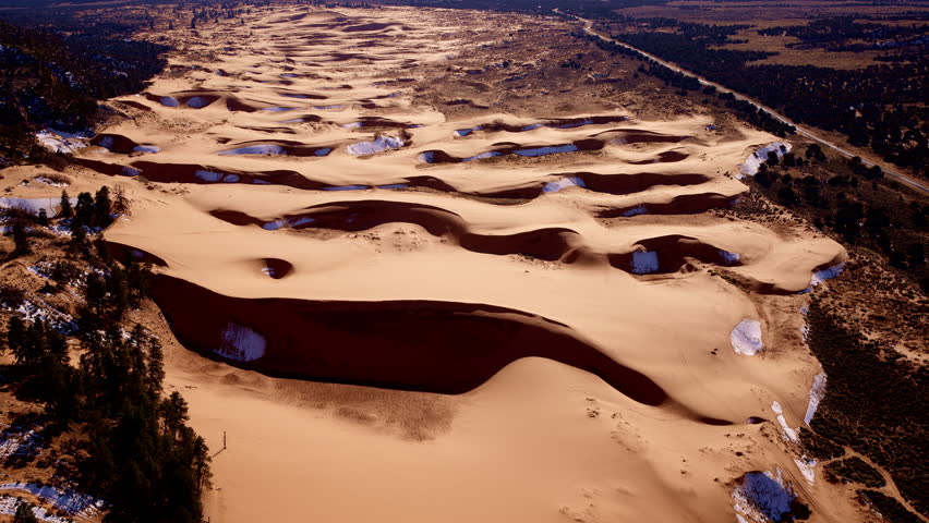 Drone view looking straight down onto a dreamscape of pink sand and dynamic shapes in southern Utah.