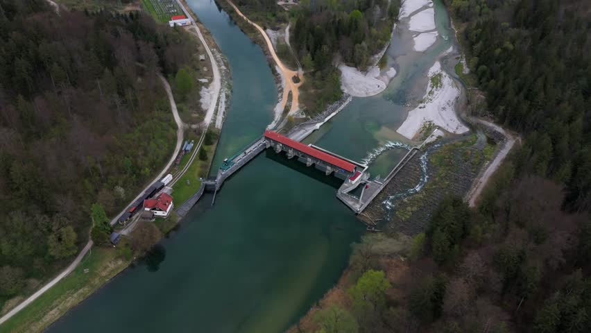 Drone footage of Baierbrunn weir, VLH turbine, and fish pass on the Isar River, Bavaria, Germany. Innovative hydropower, green energy, sustainable technology, and water engineering. Fischtreppe. 