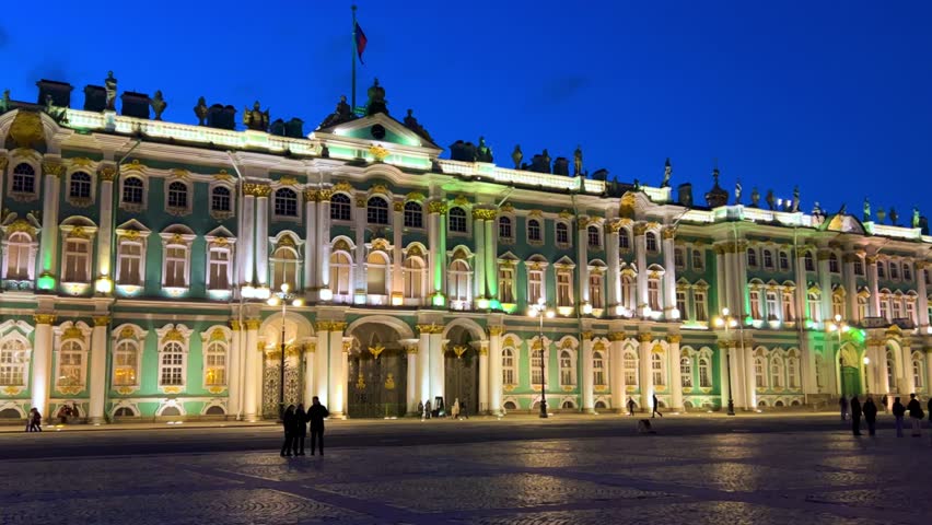 ST. PETERSBURG - APRIL 09, 2023: The Winter Palace in the night illumination on a cloudy April night. Evening view of the State Hermitage Museum in St. Petersburg. Museum on Palace Square. 4К