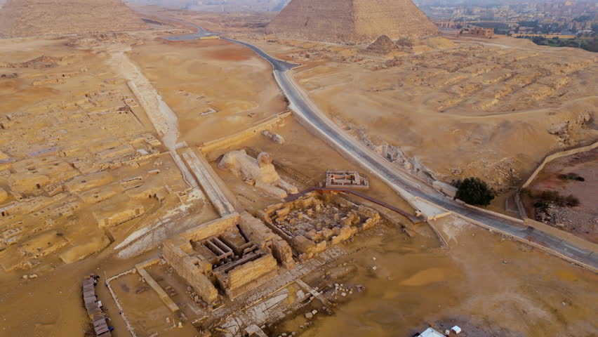Giza Necropolis - Great Pyramid, Pyramid of Khafre, Pyramid of Menkaure With Great Sphinx In Cairo, Egypt. - aerial shot