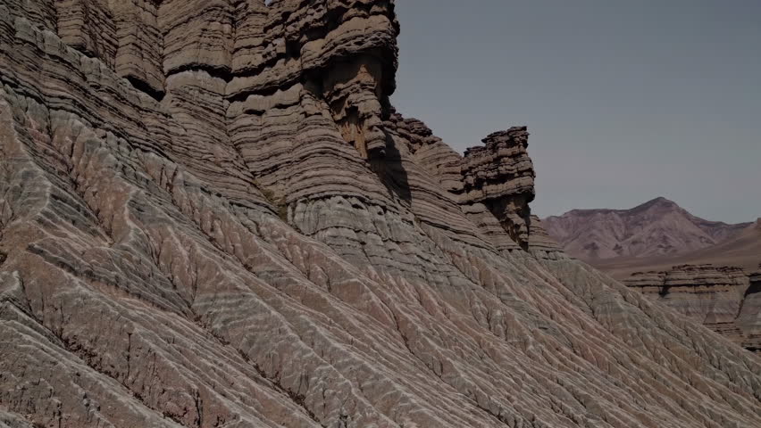 The stunning stratified rocks showcase the geological beauty of a vast desert landscape that captivates all