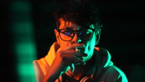 Computer Programmer or Hacker Smoking Cigarette in Front of Glitching Screen in Dark Room - Powered by Shutterstock - Get 15% off with code: PIKWIZARD15