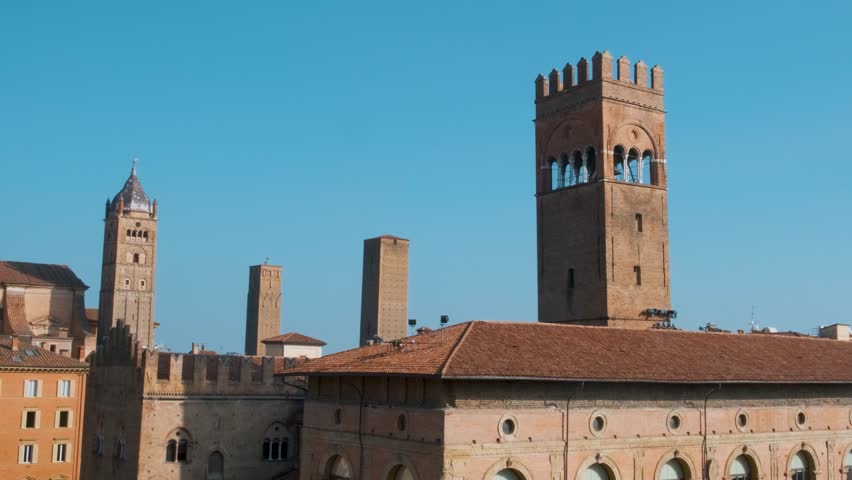 Aerial view of Piazza Maggiore in Bologna old town, Emilia Romagna, Italy, with historic architecture, Palazzo del Podesta and towers at sunrise. Italian cityscape. Travel destination in Europe