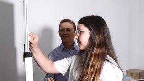 Teacher and teenager girl learn molecule at the lesson - Powered by Shutterstock - Get 15% off with code: PIKWIZARD15