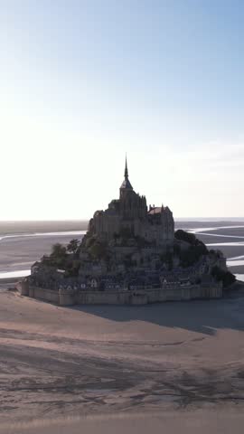 DRONE AERIAL FOOTAGE: The Mont Saint Michel and its bay at the sunset. The Abbey of Mont-Saint-Michel in Normandy, France.