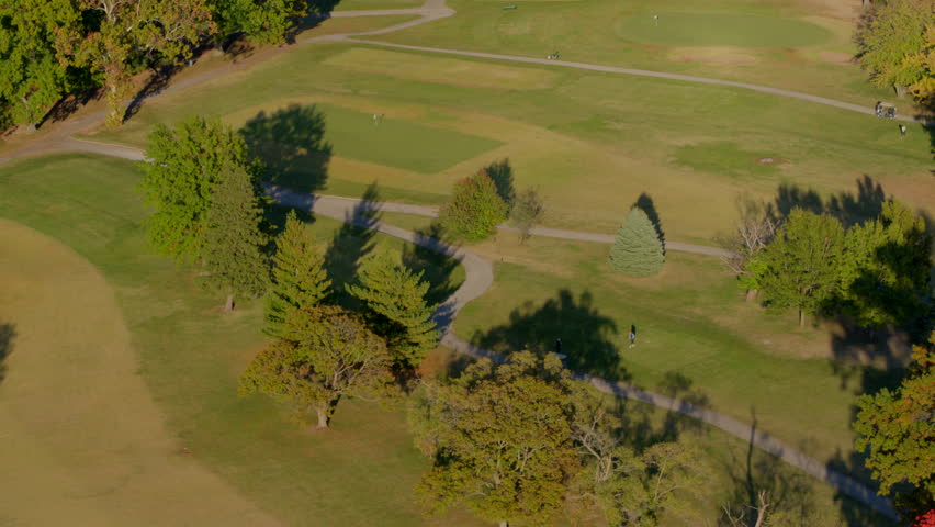 Autumn aerial of a golf course in Forest Park, St. Louis, featuring vibrant fall foliage and a tilt-up view revealing more of the park