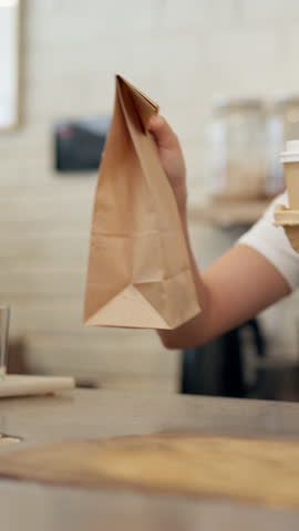 Hands, cup and customer in coffee shop, takeaway and purchase of hot beverage, barista or morning. Hospitality, consumer and server with package in small business, people or sale of breakfast in cafe