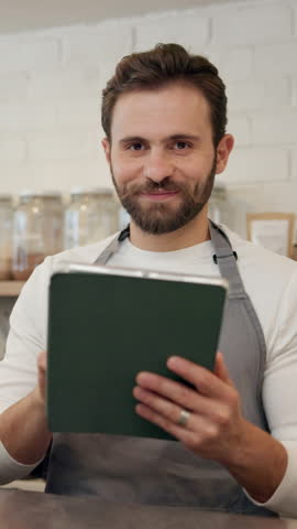 Face, barista and man with tablet in cafe for online sales, order update and check inventory. Technology, coffee shop and portrait of happy waiter on internet for reviews, stock and planning menu