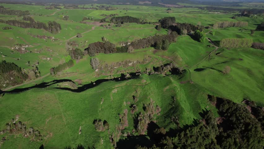 Rolling green farming lands stretch across New Zealand