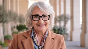 Charming senior lady with delightful glasses exuding warmth and joy while looking directly at the camera, showcasing a heartwarming smile that reflects her vibrant personality and cheerful spirit in - Powered by Shutterstock - Get 15% off with code: PIKWIZARD15