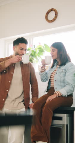 Morning, coffee and couple in home kitchen with conversation, cup and mug for drink. Discussion, communication and love of people with smile, house and marriage talking for breakfast plan with tea