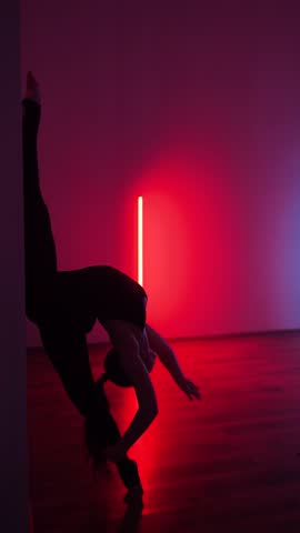 Rhythmic gymnastics performance showcasing flexibility and artistry in studio setting