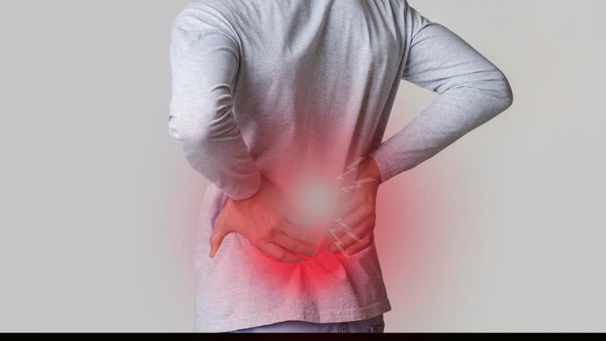 Back Pain Affecting Mobility and Daily Activities. Lower back pain in spine, inflamed zone highlighted in red.