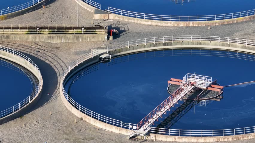 Sideways aerial view of large pools at a water treatment plant