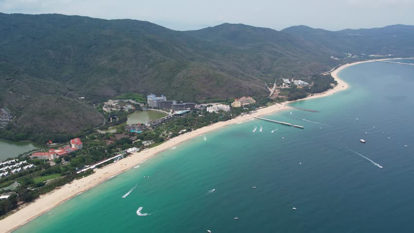 Sanya, Hainan, China. Top View of luxury beach with palm trees against the background of the beauty of the sea with coral reefs. Travel summer holiday background concept