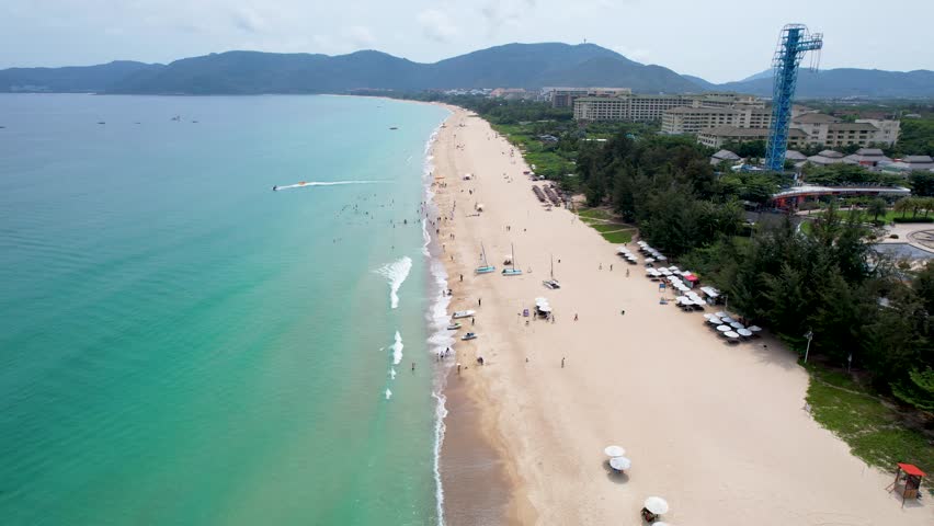 Sanya, Hainan, China. Top View of luxury beach with palm trees against the background of the beauty of the sea with coral reefs. Travel summer holiday background concept