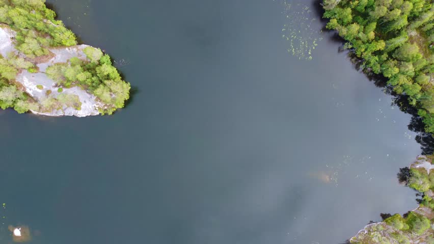 Russia, Lake Ladoga, Koyonsaari. View of the coast of the island in a cold lake. Beautiful nature of the Republic of Karelia. Panoramic view from the height of the Ladoga skerry islands. 4K