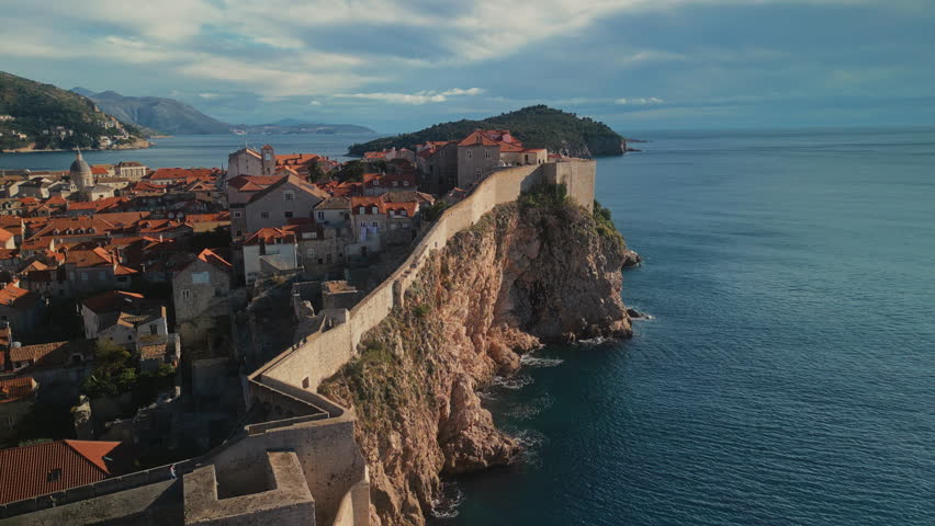 St Lawrence fortress with fortified wall on steep cliff in Dubrovnik Croatia camera moving around. Medieval fort protecting city from conquerors in Adriatic sea aerial panorama