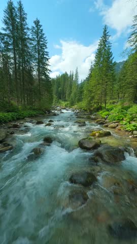 Flight over a mountain river. Shot on FPV drone. Tatra Mountains, Slovakia.
