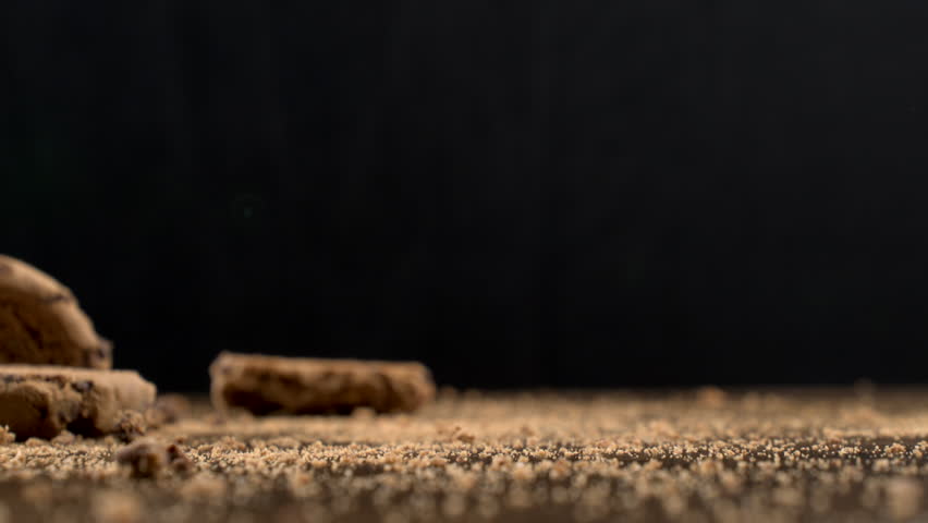 Detailed Slow Motion Footage of a Chocolate Donut with Sprinkles Descending onto a Table Filmed in Macro at 1000 Frames Per Second