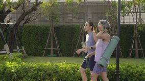 Young adult child and mature middle age old mum public park walk workout with yoga mat water bottle. Love health care older mom asia elder people happy protect aging life enjoy sport club class active - Powered by Shutterstock - Get 15% off with code: PIKWIZARD15