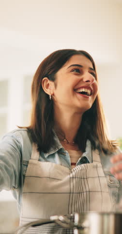 Cooking, steam and woman in kitchen in home with meal, dinner or supper for diet, wellness or health. Nutrition, laugh and female chef preparing food for lunch with conversation, recipe or aroma.