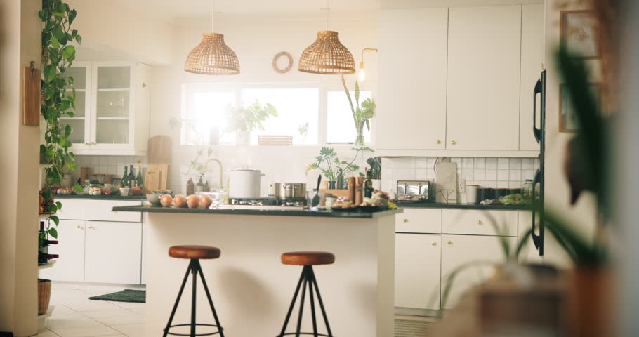 Kitchen, pot and cooking on stove for meal, food preparation and interior of home. Apartment, steam and cookware on gas range for dinner, fresh ingredients and chairs at island bench for aesthetic
