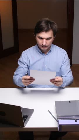 vertical video Office worker tearing paper at desk expressing frustration